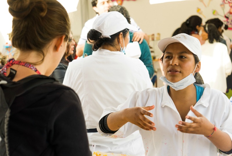 Simone trying to find out what the local dessert are in a market in Boyaca dedicated just to desserts!